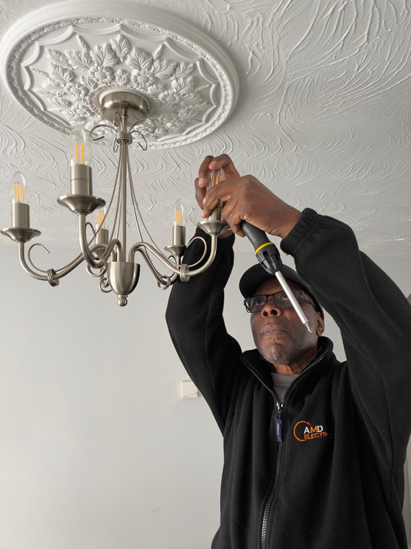 Andy from AMD Electrics fitting a light